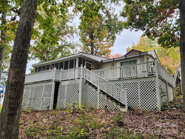 back of house featuring a wooden deck