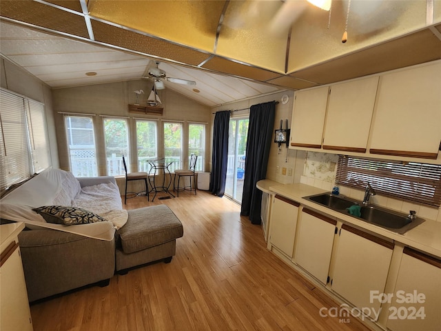 kitchen featuring ceiling fan, white cabinetry, a textured ceiling, light hardwood / wood-style flooring, and sink