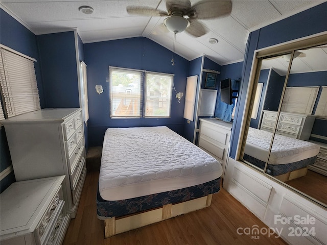 bedroom with dark hardwood / wood-style flooring, a closet, lofted ceiling, and ceiling fan