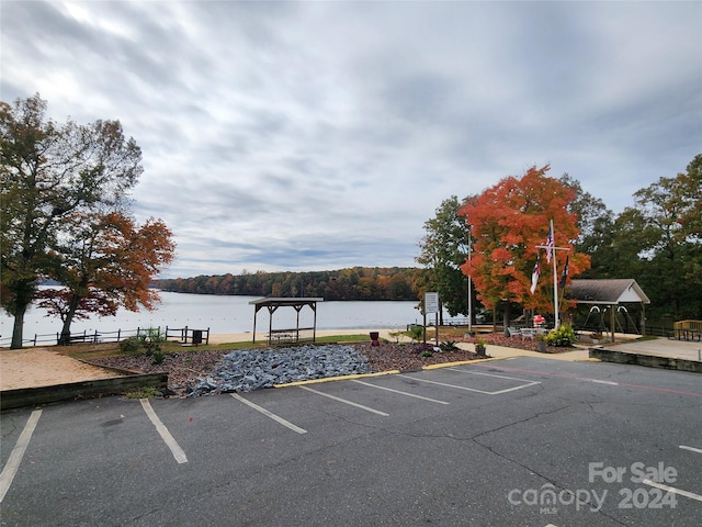 view of parking / parking lot with a water view