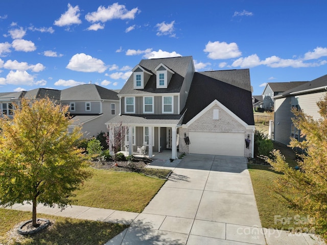 view of front of home featuring a garage, a front lawn, and a porch