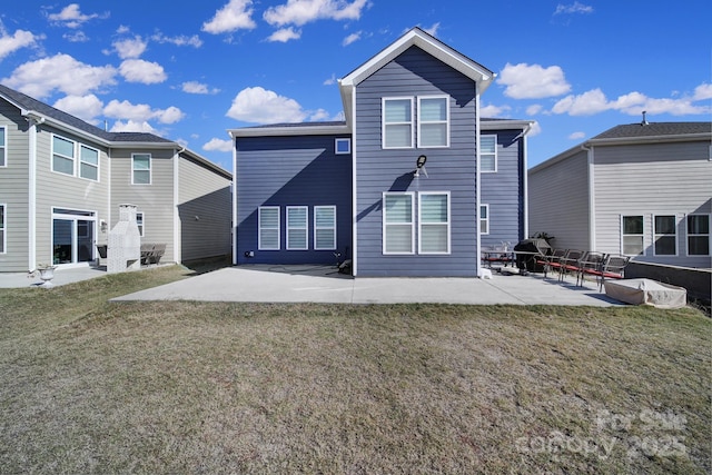 back of property with a patio and a lawn