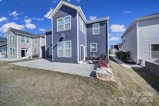 rear view of house with a patio area and a yard