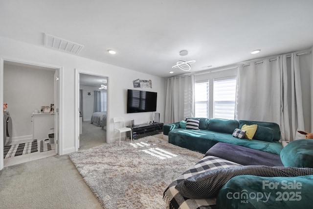 carpeted living room with baseboards, visible vents, and recessed lighting