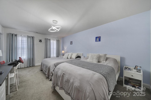 carpeted bedroom featuring visible vents and baseboards