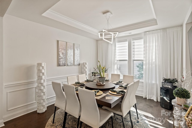 535 Red Wolf Ln, Lake Wylie, SC 29710 - dining space featuring a raised ceiling, a chandelier, dark wood finished floors, a wainscoted wall, and ornamental molding