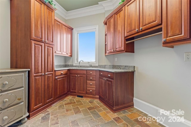 kitchen with ornamental molding and sink