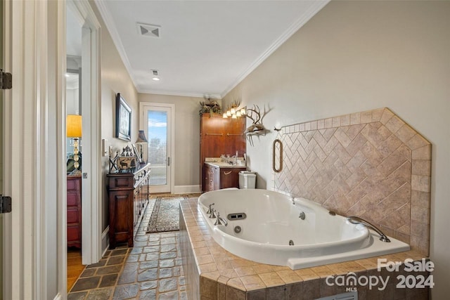 bathroom with vanity, a relaxing tiled tub, and ornamental molding