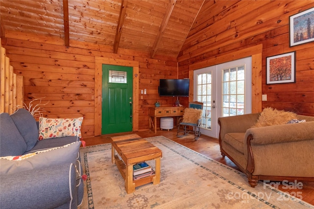 living room featuring french doors, wooden ceiling, wooden walls, and vaulted ceiling with beams