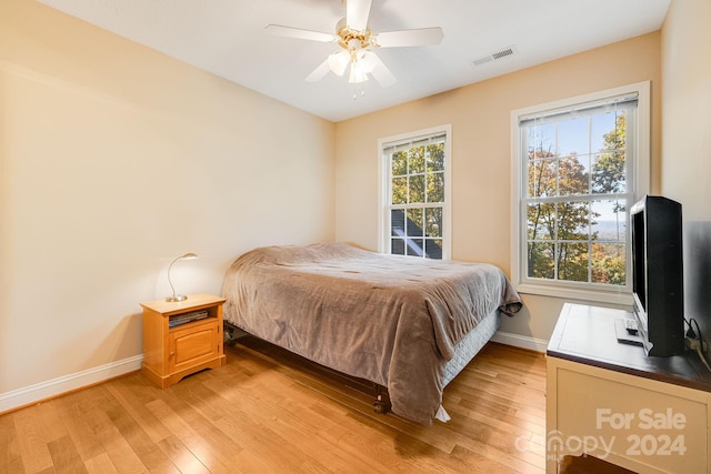 bedroom with ceiling fan and light hardwood / wood-style floors