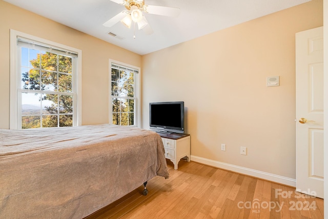 bedroom with light wood-type flooring and ceiling fan