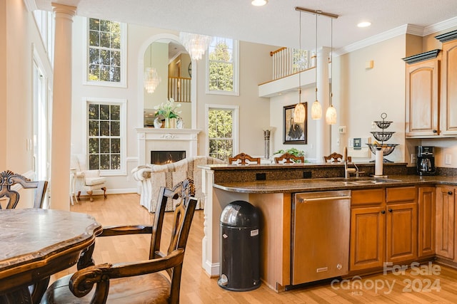 interior space featuring light hardwood / wood-style flooring, hanging light fixtures, a textured ceiling, and sink