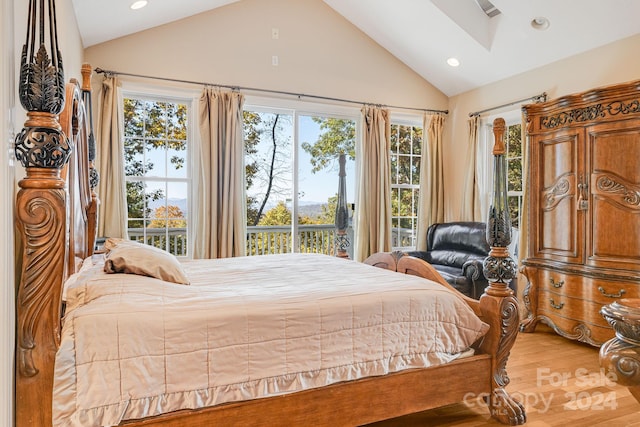 bedroom with wood-type flooring, access to outside, and lofted ceiling