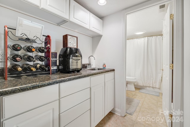 bathroom with tile patterned floors, vanity, and toilet