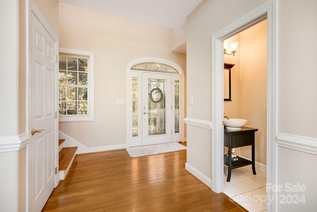 foyer featuring light wood-type flooring and sink