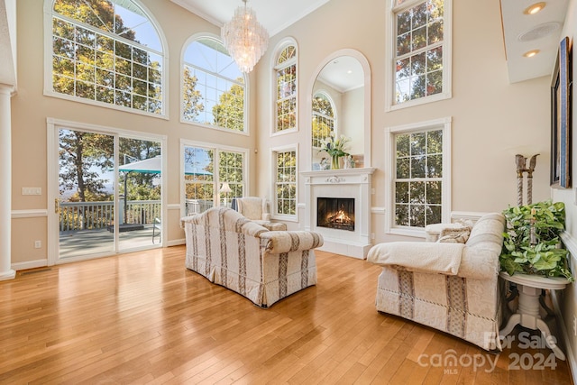 sunroom featuring a healthy amount of sunlight and a notable chandelier