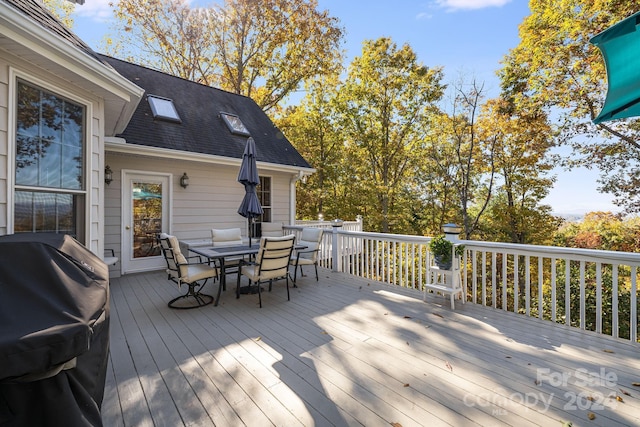 wooden terrace featuring a grill