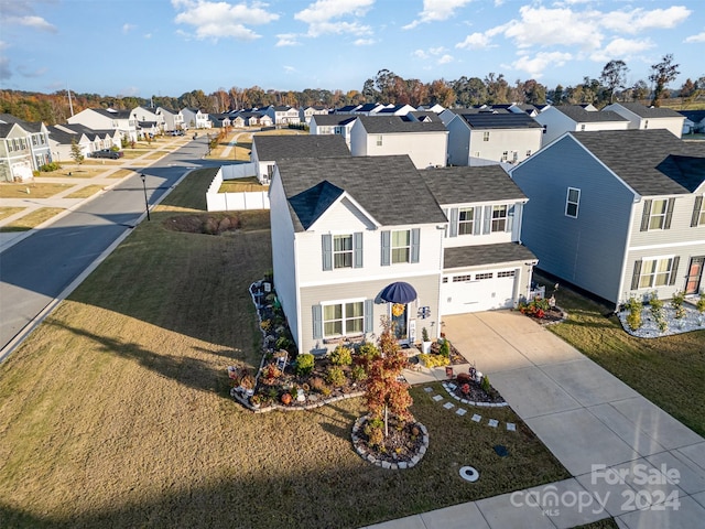 view of front facade with a front lawn and a garage