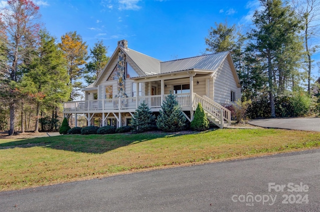 view of front of home featuring a front yard and a porch