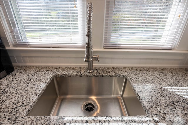 room details with light stone counters and sink