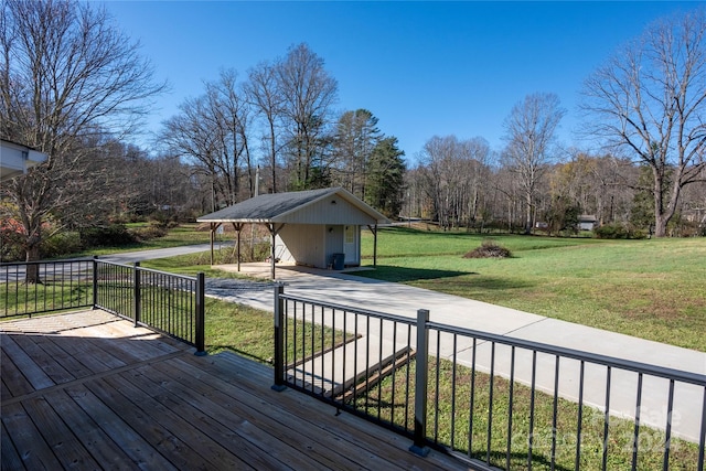 wooden terrace featuring a yard