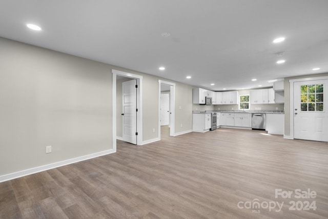 unfurnished living room with light wood-type flooring