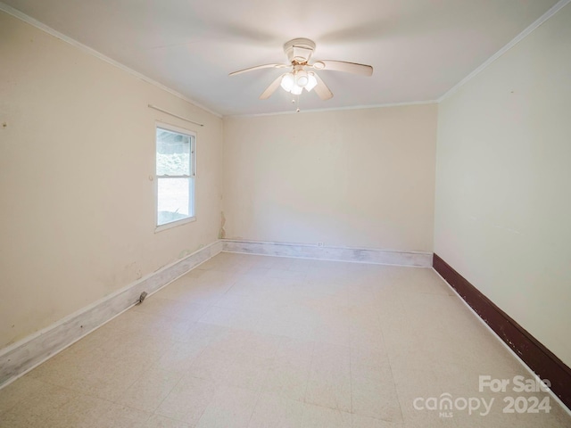 empty room featuring ornamental molding and ceiling fan