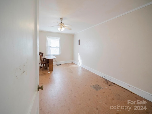 spare room featuring ornamental molding and ceiling fan