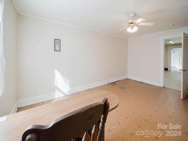 dining area with crown molding and ceiling fan