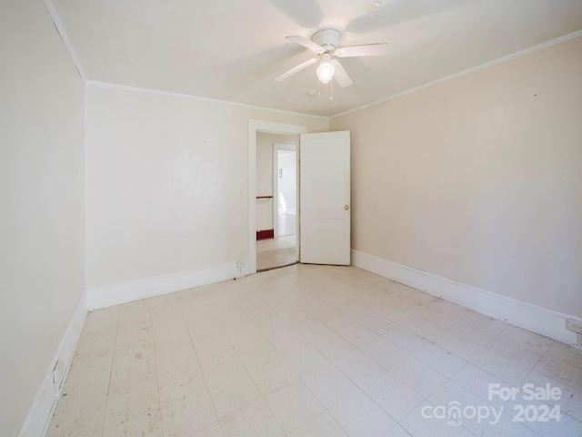 spare room featuring ceiling fan and ornamental molding