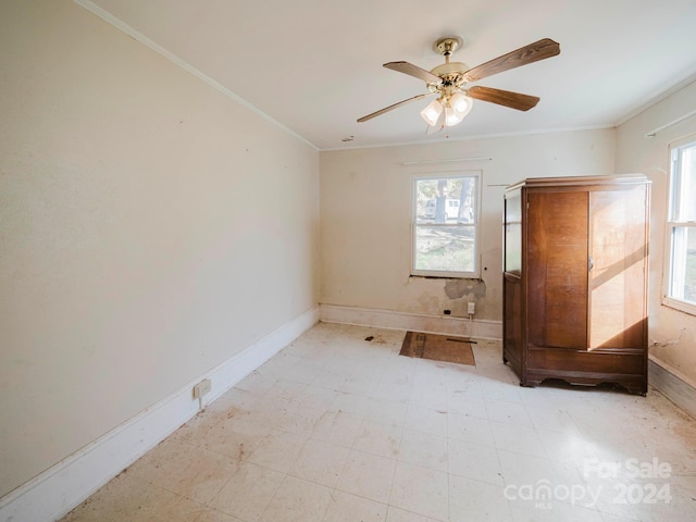 unfurnished room with crown molding and ceiling fan