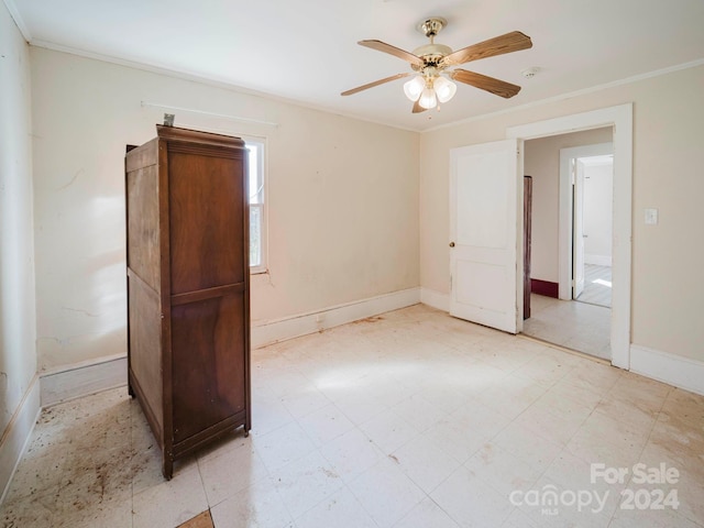 empty room with crown molding and ceiling fan