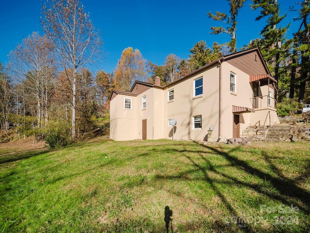 view of side of home featuring a yard