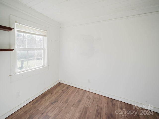 unfurnished room with wood-type flooring