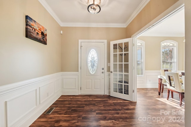 entrance foyer with dark hardwood / wood-style flooring and crown molding