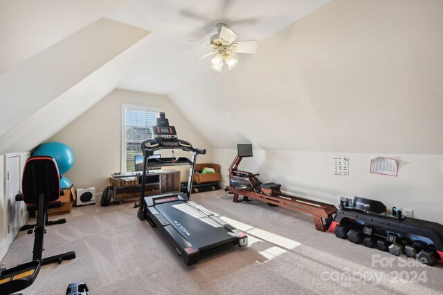 workout area featuring light colored carpet, ceiling fan, and vaulted ceiling