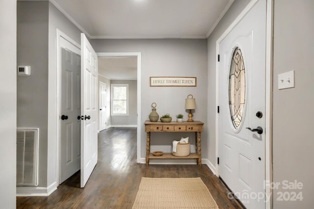 foyer entrance featuring dark wood-type flooring and crown molding