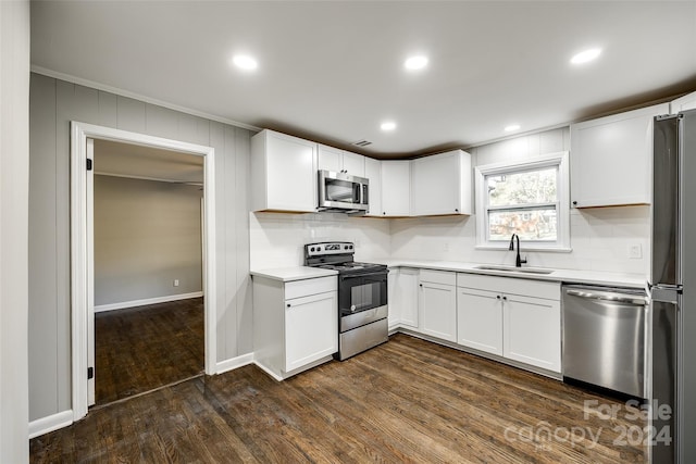 kitchen with white cabinetry, appliances with stainless steel finishes, dark hardwood / wood-style flooring, and sink