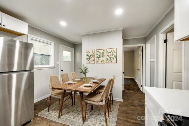 dining room featuring dark wood-type flooring and crown molding