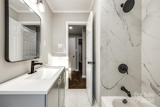 bathroom with vanity, crown molding, and tiled shower / bath combo