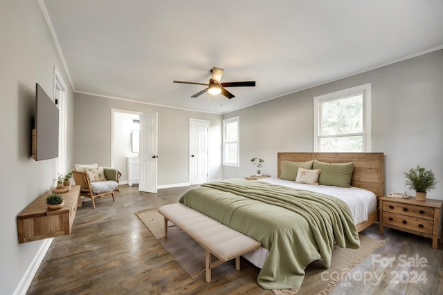 bedroom featuring ornamental molding, dark wood-type flooring, multiple windows, and ceiling fan