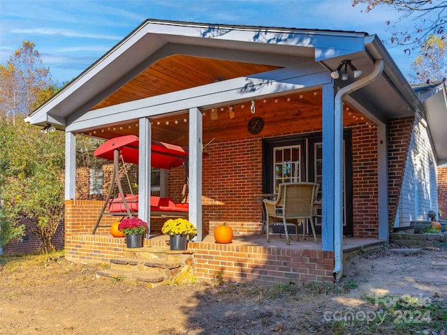 1000 Mountain View Church Rd, Zirconia, NC 28790 - rear view of property featuring brick siding and a porch