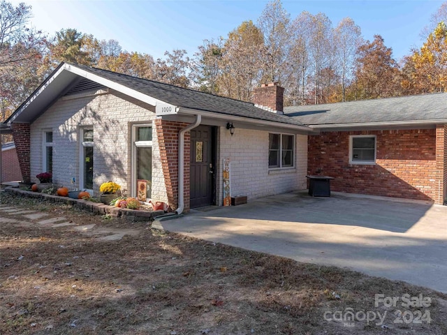 back of property with a patio