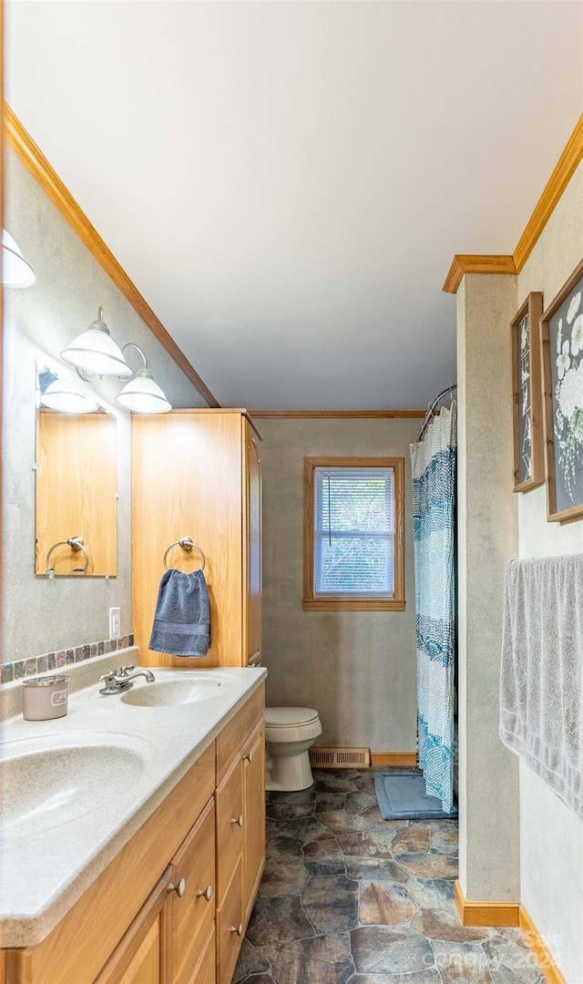 bathroom featuring vanity, toilet, crown molding, and a shower with shower curtain