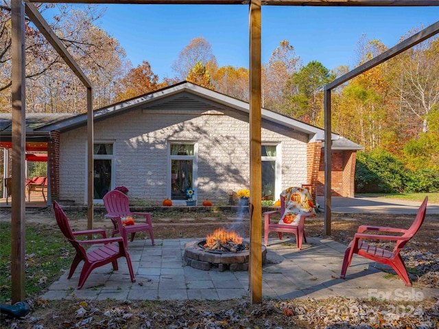 back of house featuring a patio and an outdoor fire pit