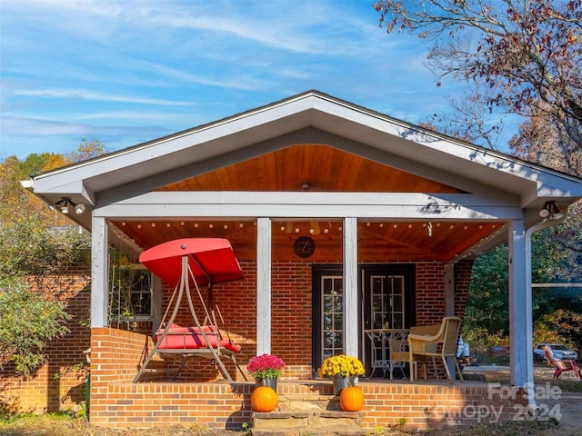 1000 Mountain View Church Rd, Zirconia, NC 28790 - doorway to property featuring a porch and brick siding