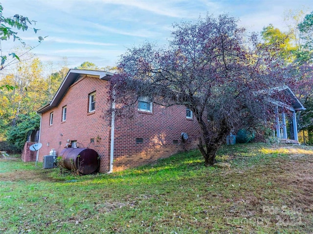1000 Mountain View Church Rd, Zirconia, NC 28790 - view of side of home with heating fuel, a yard, and brick siding