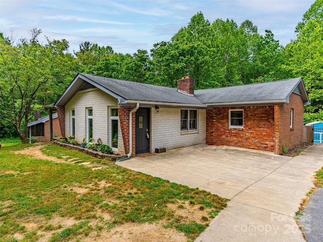 1000 Mountain View Church Rd, Zirconia, NC 28790 - ranch-style house with a chimney, a front lawn, brick siding, roof with shingles, and a patio