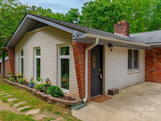 1000 Mountain View Church Rd, Zirconia, NC 28790 - view of front of home featuring brick siding, a chimney, and roof with shingles