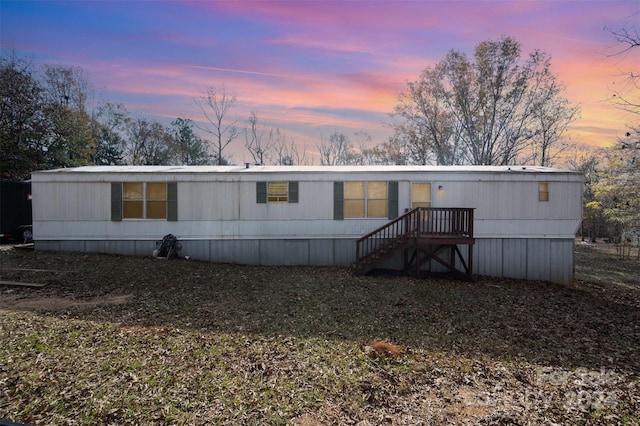 view of back house at dusk